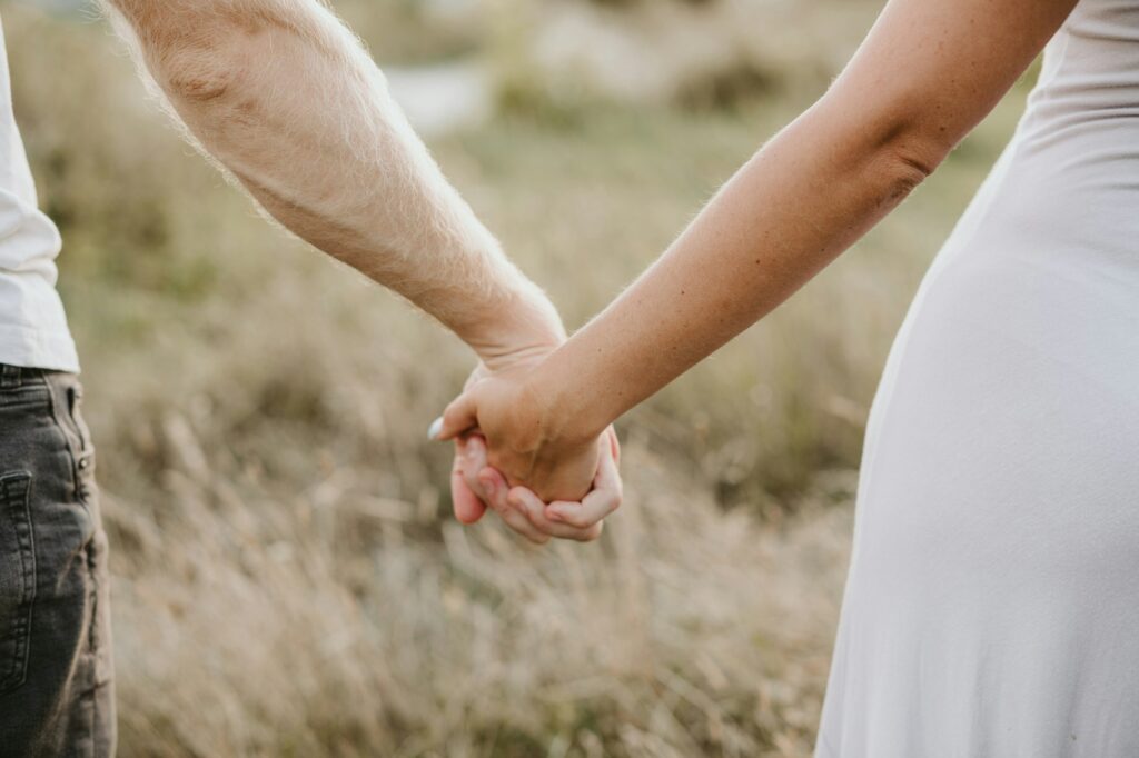 Happy couple holding hands on nature