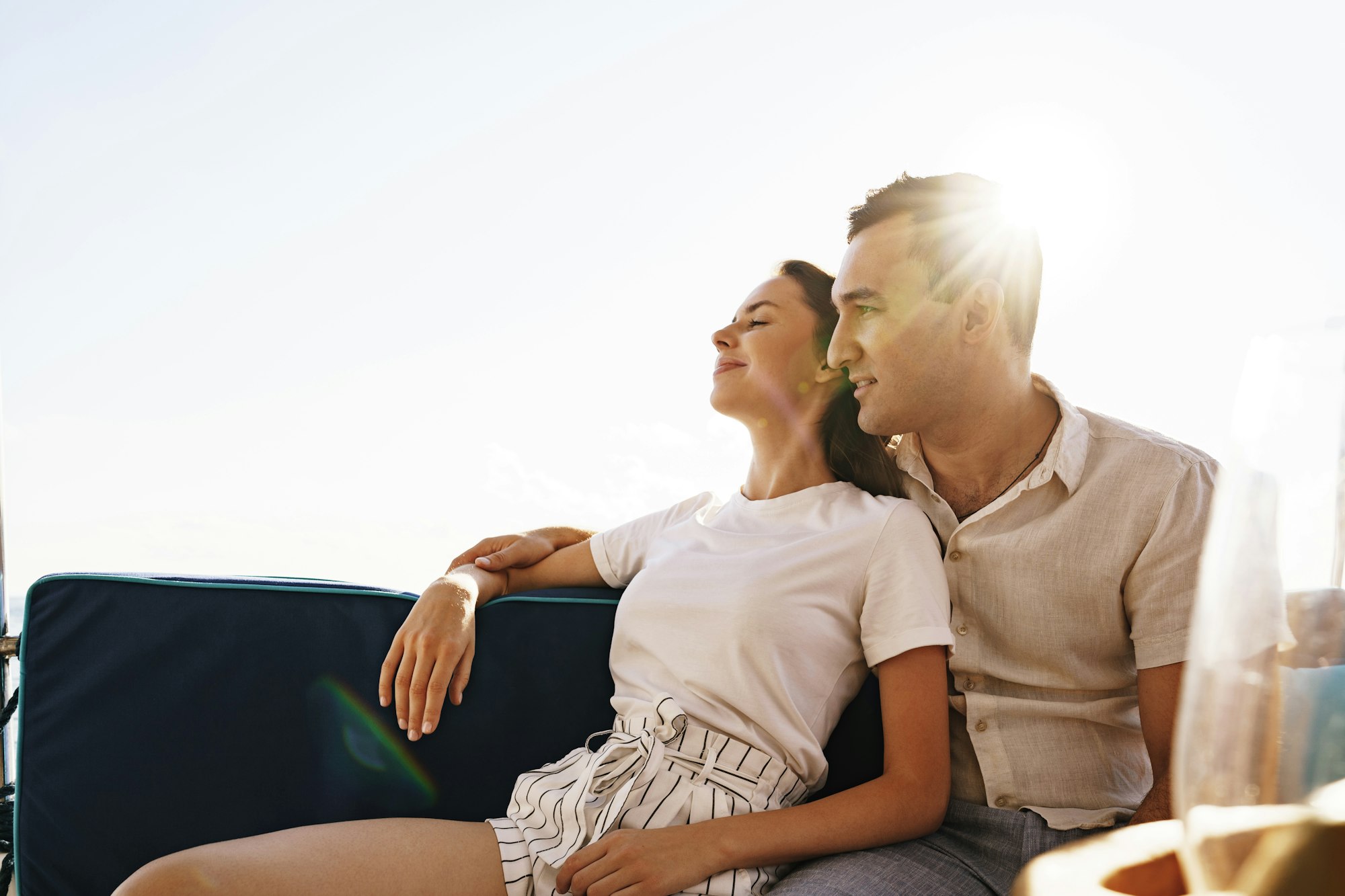 Happy couple on a yacht in summer on romantic vacation