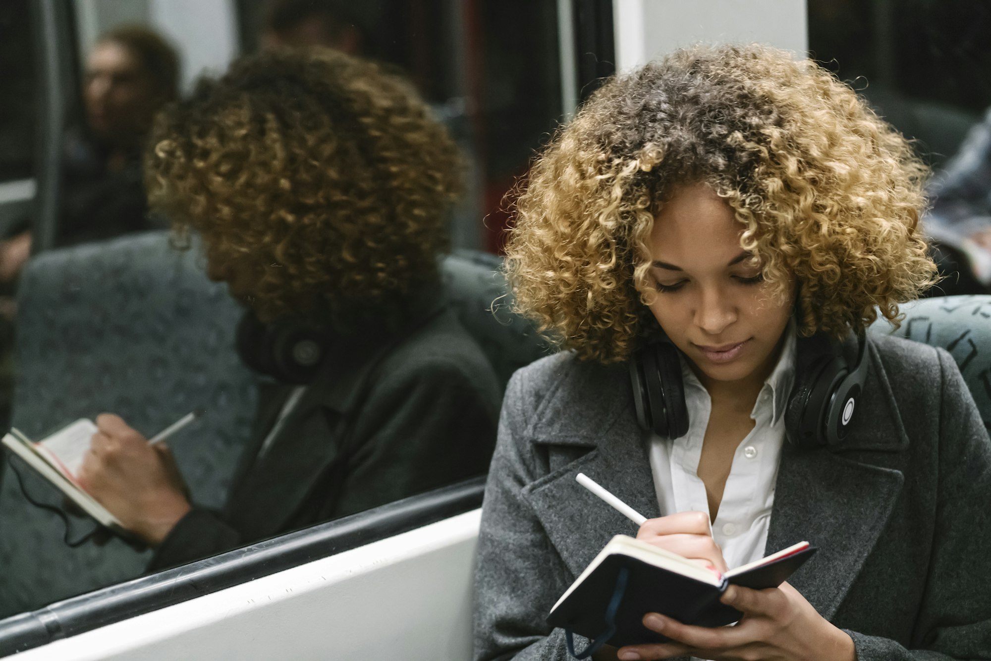 Woman taking notes on a subway